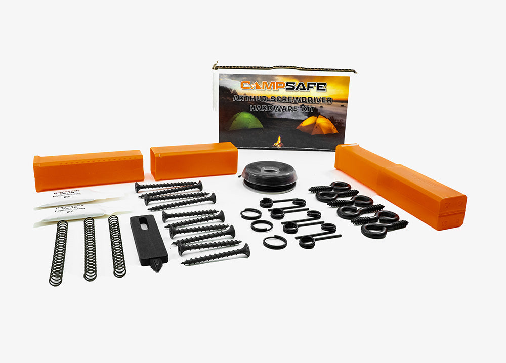 [An array of essential accessories for the Fith Ops Perimeter Trip alarm laid out on a white background, including multiple screws, springs, trip wire, extra pins and small gun oil and orange plastic case for quick and easy packing!]]