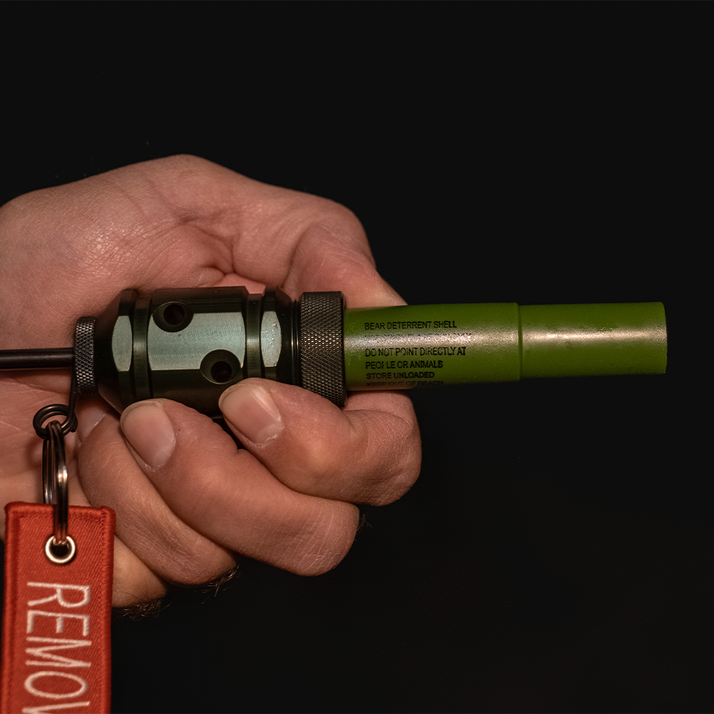[Hand holding the Fith Ops Gen4 2-in-1 Rescue Device with OD Green Waterproof Sight and Sound Shells]]