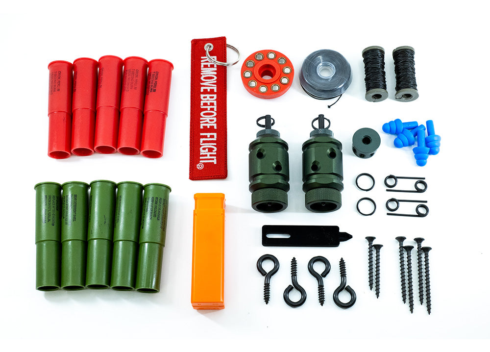 [Fith Ops Gen4 Perimeter Trip Alarm, Eye Screws, Orion Sight and Sound Shells, CCI Primers in Carrier Caddy, 75' Dyneema Trip Line, Extra Pins, Extra Screws, 209 Adapter and Authur Screw Driver laid out with white background straight down view]]
