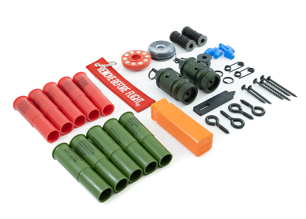 [Fith Ops Gen4 Perimeter Trip Alarm, Eye Screws, Orion Sight and Sound Shells, CCI Primers in Carrier Caddy, 75' Dyneema Trip Line, Extra Pins, Extra Screws, 209 Adapter and Authur Screw Driver laid out with white background]]