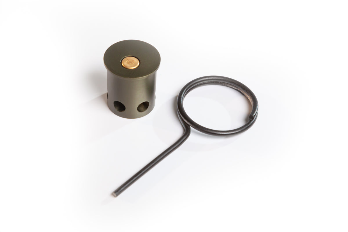 [.22 adapter for 12g trip alarm: cylinder shape device with holes at the bottom  (flashport), hole is not center for rim fire, with a large ejector pin.]]